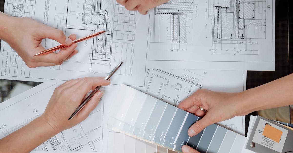Team working together on architectural blueprints and color swatches.